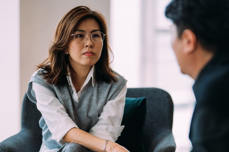 A female counsellor listening to her client as he speaks